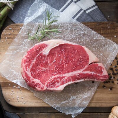 Raw dry-aged grass-fed boneless ribeye steak from Longbottom Farm displayed on cutting board