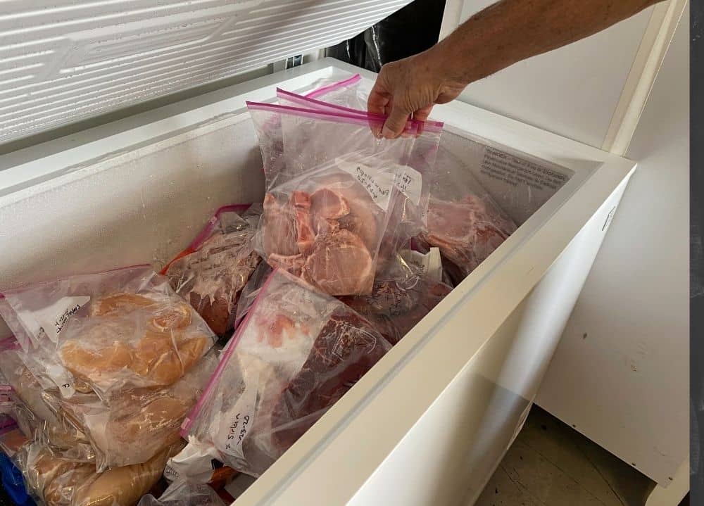 Messy freezer representing 5 tips for organinzing farm purchased meats in your freezer