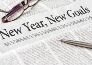 news paper that reads, "new year, new goals" representing goals we have on the farm